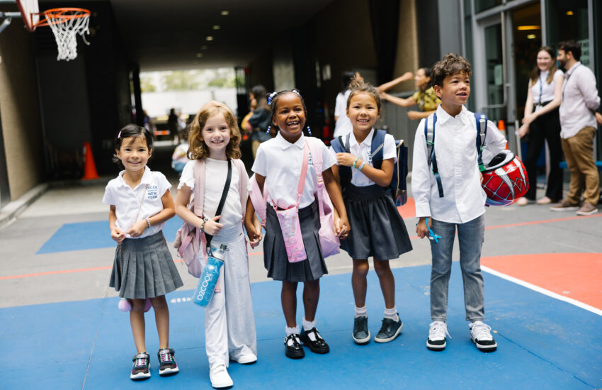 Five students in first grade arrive for their first day of school.