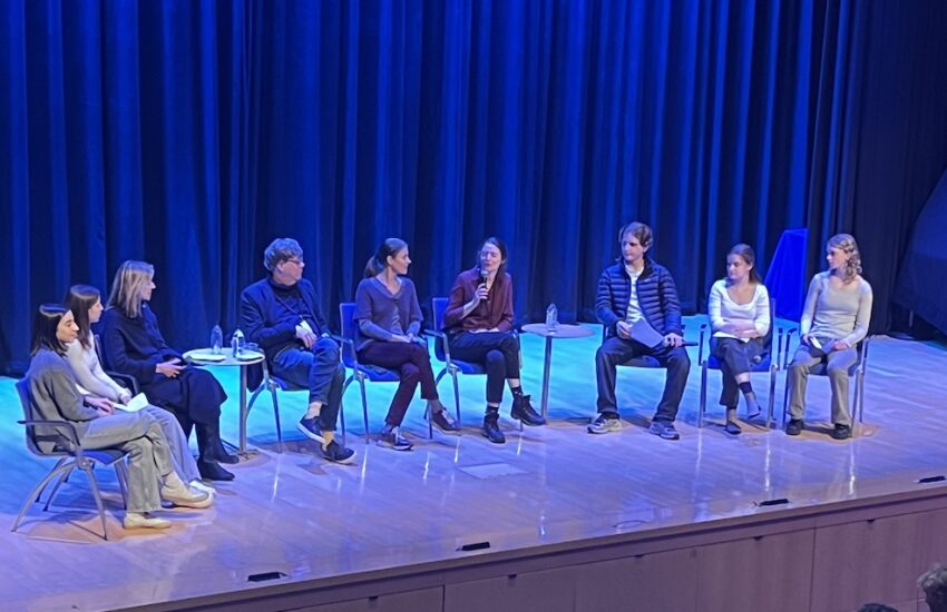 Panel of students interview three journalists on stage