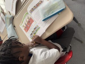 Young student working on math textbook